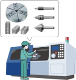 治具を設定する機械とそれを操作する人のイメージ画像
